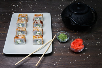 japanese rolls served on plate on dark table