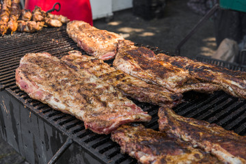 Cooking pork ribs on a grill. Meat on a grills.