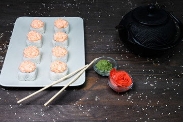 japanese rolls served on plate on dark table