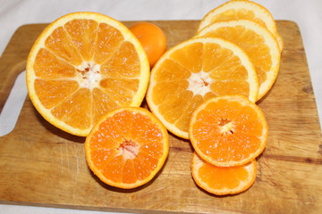 Mandarin and orange on the Board a background of orange juicy delicious vitamin healthy