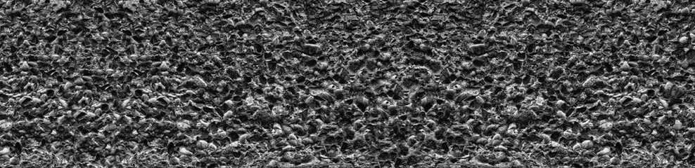 Wide gray stone wall - cement mortar with pebbles texture