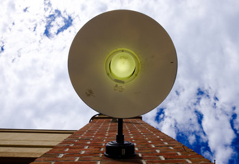 Looking up at isolated wall lamp. Minimal street photography. Building facade exterior with wall...