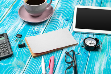 Modern workplace with cup of coffee on wooden table