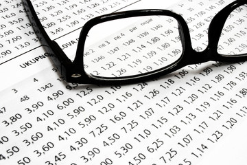 A sport betting list with glasses