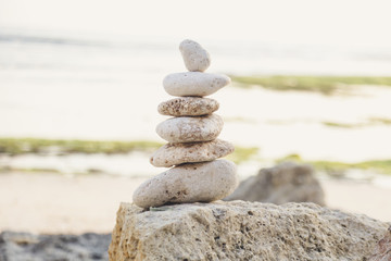 
Balanced Zen stones on blurred beach background, concept of balance and harmony