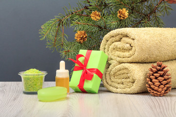 Fototapeta na wymiar Spa composition with towel, aromatic oil, gift box, sea salt and soap