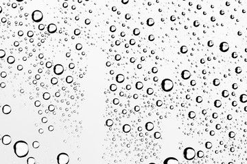 white isolated background water drops on the glass / wet window glass with splashes and drops of water and lime, texture autumn background