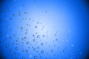 fresh drops background blue glass / wet rainy background, water drops transparent glass blue