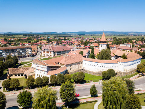 Prejmer Fortified Church, Brasov County, Transylvania, Romania. Medieval fortress with a church, clock tower, high spire, red tiled roof, sthick walls