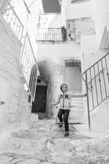 Boy runing in stairs in the city Ostuni in Plugia, Italy - commonly referred to as "the White Town".