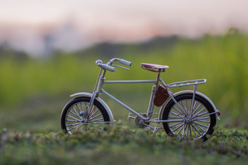 Fototapeta premium White bike in the field with the evening sky.