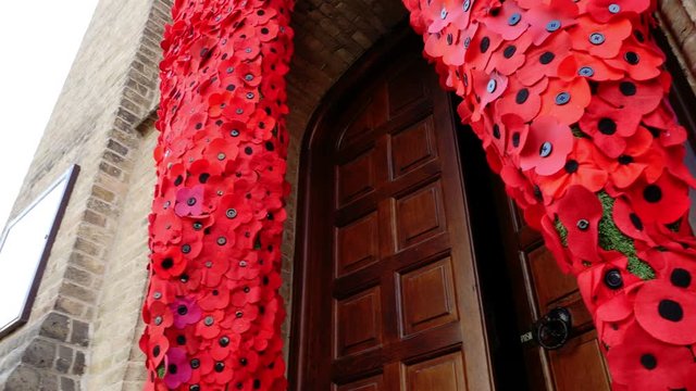 WW1 remembrance, Ypres, Belgium : thousands of knitted  poppies  cascading down the front of St Georges Memorial Church