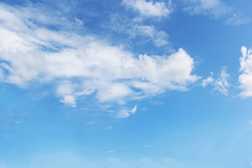 Blue sky background and white clouds soft focus, and copy space