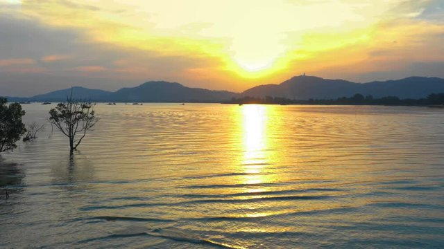 aerial view sunset in Mudong canal conect to Chalong bay. Klong Mudong canal has perfect mangrove forests..from here can see the Phuket big Buddha statue on the top of mountain.