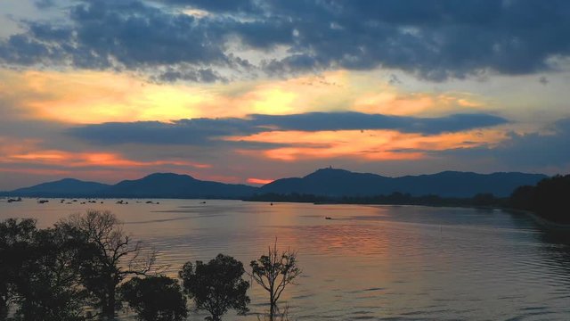 aerial view sunset in Mudong canal conect to Chalong bay. Klong Mudong canal has perfect mangrove forests..from here can see the Phuket big Buddha statue on the top of mountain.