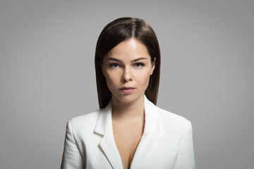 Woman with straight hair. Portrait of a business woman. White formal suit