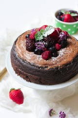 Homemade Chocolate Quinoa Cake topped with fruits and berries