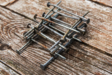 Old rusty nails on wooden background. Nails on wooden table