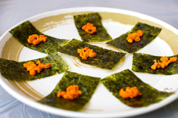 Delicious Uni sashimi is served on dried salty seaweed. It is very famous menu with premium taste of many seafood restaurants in Busan, South Korea.  