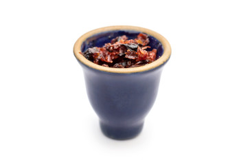 Bowl for hookah with fruit tobacco on white.
