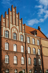 Fototapeta na wymiar The historic red brick building in the city of Gniezno.