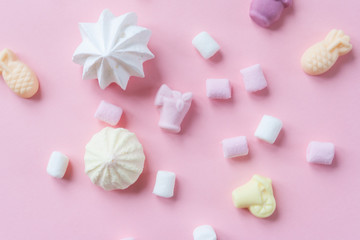 Fototapeta na wymiar various pastel marshmallows on a pink background