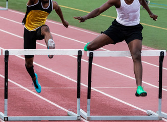 Two hurdlers fighting down the final straigtaway
