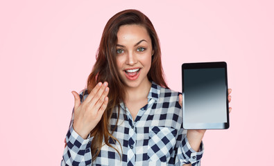 Shocked woman showing tablet