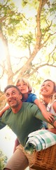 Fototapeta premium Family arriving in the park for picnic on a sunny day