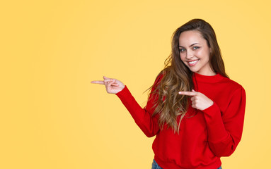 Naklejka premium Smiling teenage pointing away