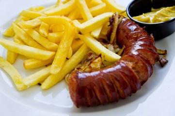 French fries and sausage served on a plate