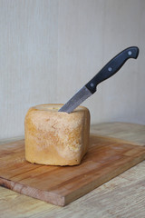 Homemade, fresh, hot, baked bread with a knife