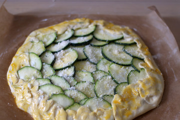Preparing zucchini and cheese galette. Galette ready for baking. Selective focus. 