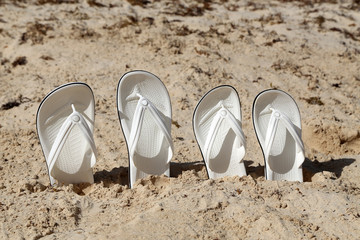 White sandals. White sandals on the beach.