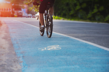 People are cycling on highways with dedicated bicycle lanes and soft light from the front, safe driving, cyclists on bike trails, Cycling for health, Exercise with cycling, Bike, Bycicle.