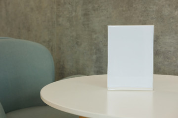 white label in cafe. display stand for acrylic tent card in coffee shop. mockup menu frame on table in restaurant.