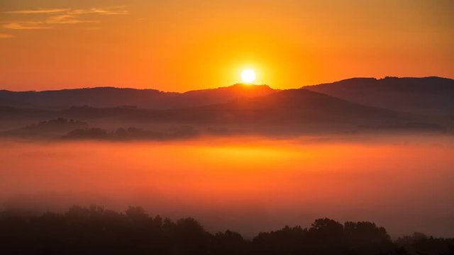 4K Time lapse of sunrise at misty morning, Tuscany, Italy