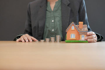 house model & coins stack. saving money for buying house property. real estate investment