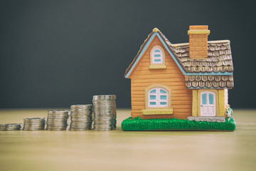 house model & coins stack. saving money for buying house property. real estate investment