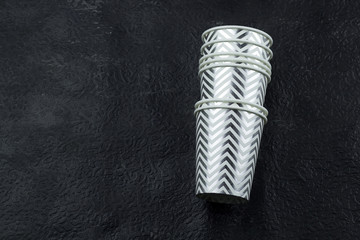 top view silver stripped paper cups black background