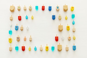 Image of jewish holiday Hanukkah with wooden dreidels colection (spinning top) over white background.