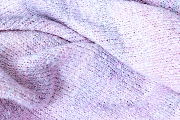 Fototapeta na wymiar Knitted texture of white, pink, lilac and blue colors