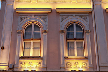 Two windows of the building illuminated by night illumination