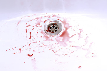 Blood stains in the bathroom sink, bleeding, criminal and suicide concept