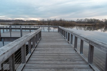Wood fishing dock over Purgatory Creek at sunset in Autumn