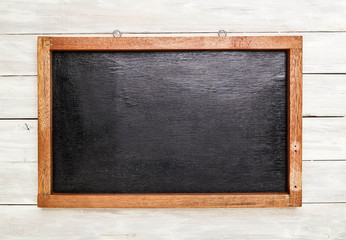 Fototapeta na wymiar Blackboard in wooden frame on wooden wall