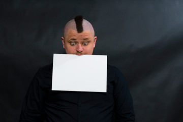 Subculture punk. Iroquois. On the face reflected question. He holds a clean white sheet in his...