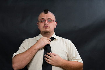 Subculture punk. Iroquois. Looking at the lens. Straightens dark tie. The face is serious and...
