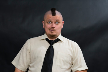 Close-up photo of young punk. Builds a funny physiognomy in front of a photo lens.
