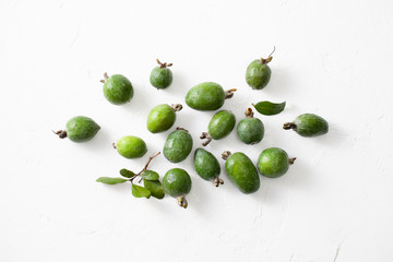 Fresh raw feijoa fruit on white concrete background